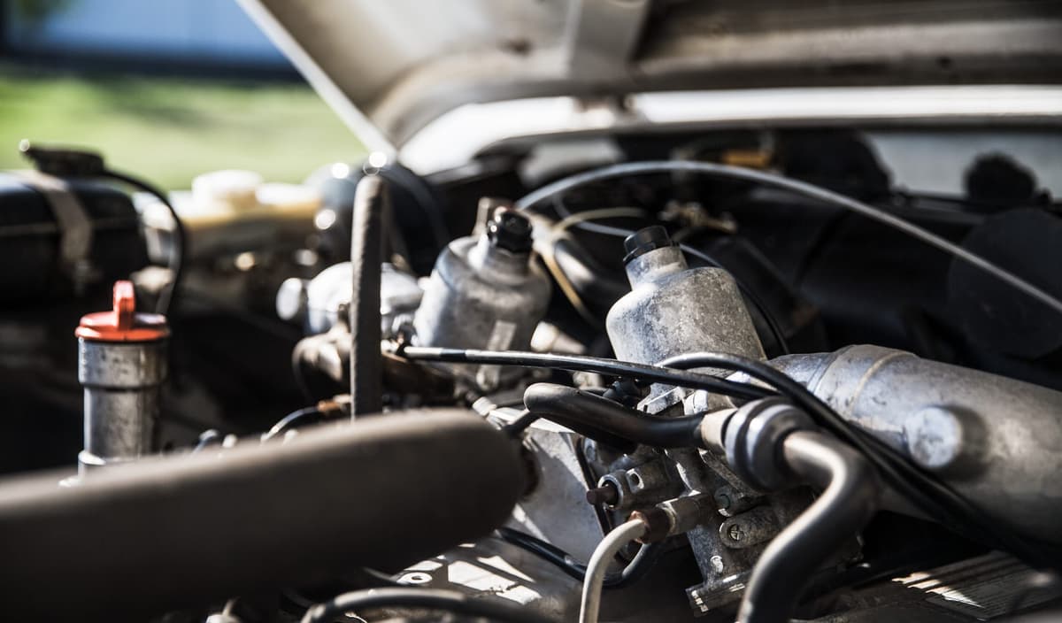 An open Defender engine bay during a sunlit inspection