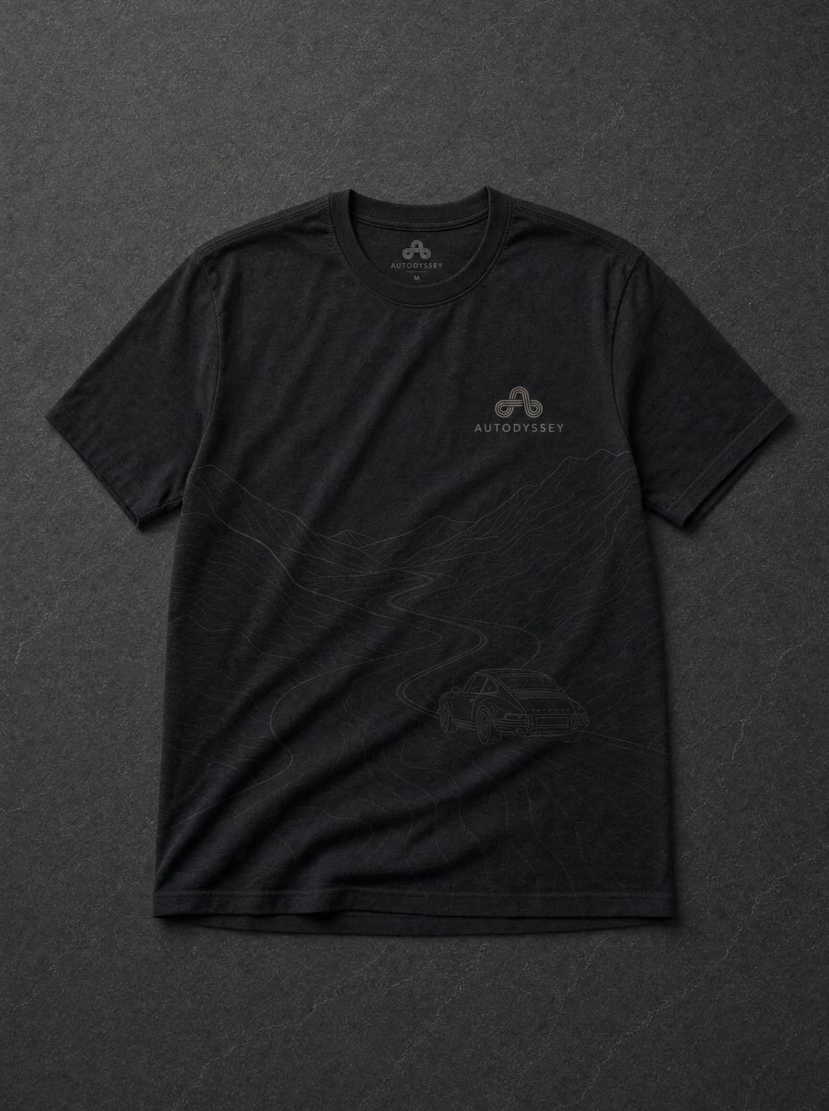 The charcoal Model Line tee with a contour road print and a 911 drawn mid-descent