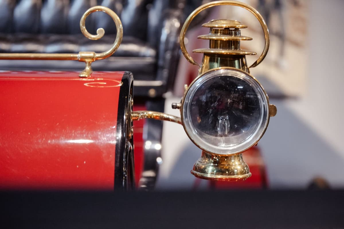 Brass headlamp on red veteran